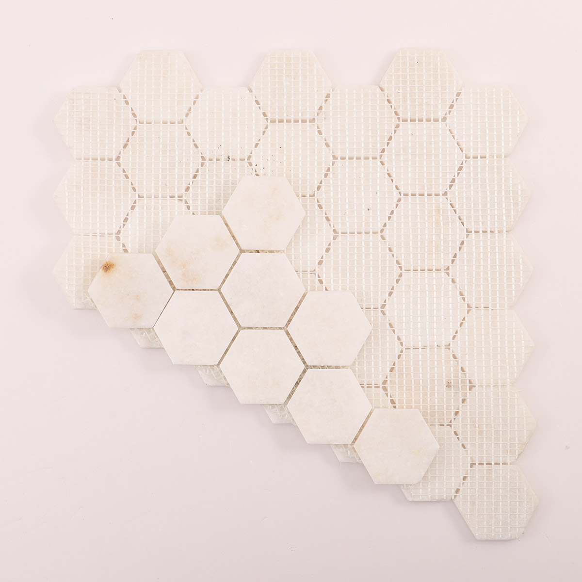Folded back side of crystal white hexagon marble mosaic tiles.