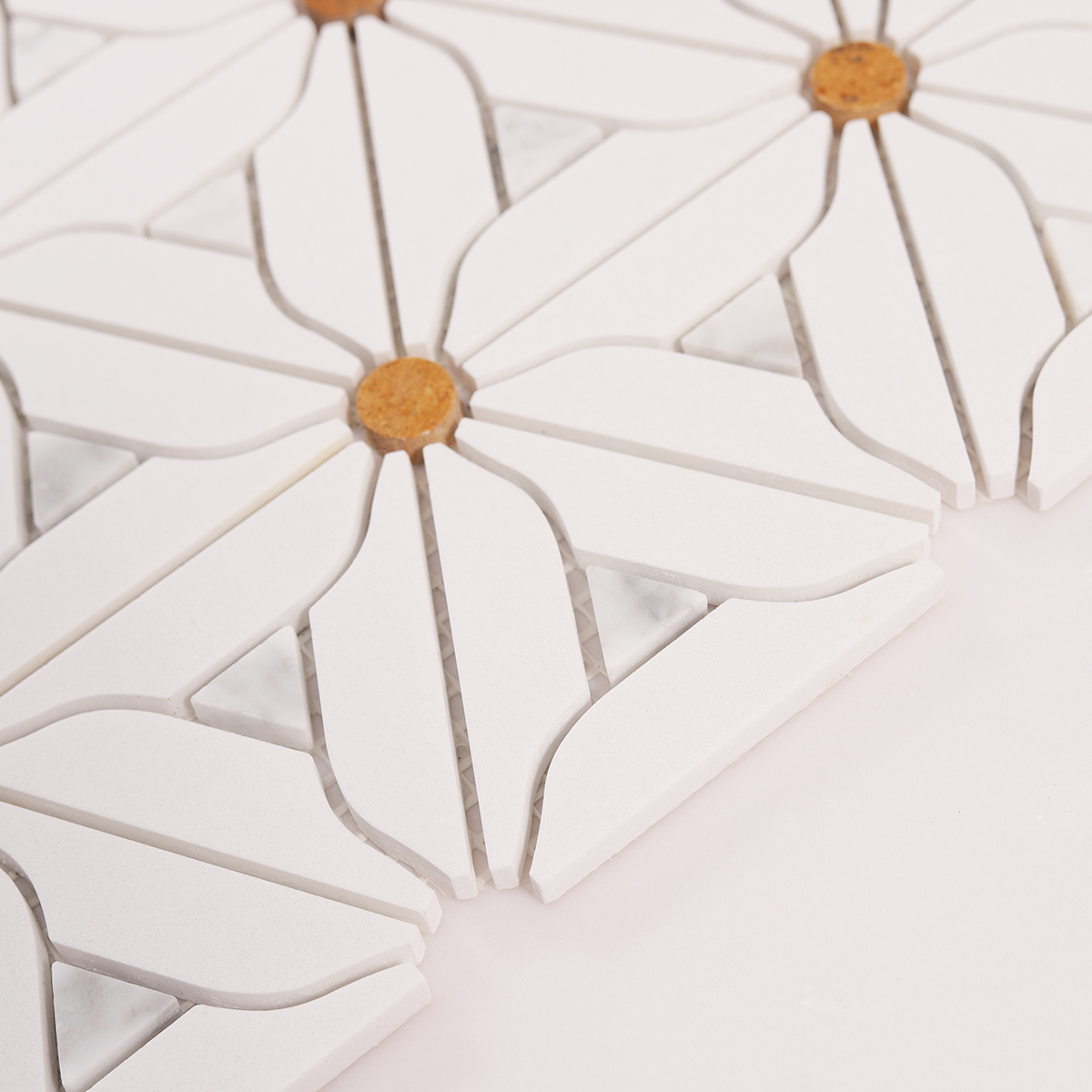 Side close-up view of white floral marble mosaic tiles, showing texture and thickness.