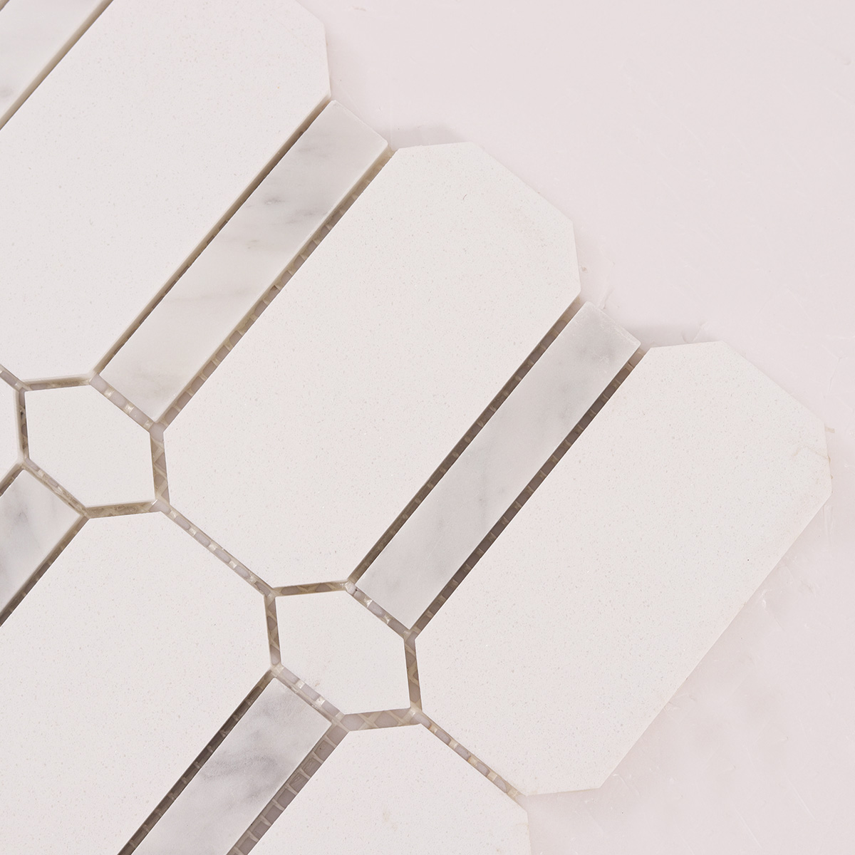 Detailed close-up of white octagon marble mosaic tiles