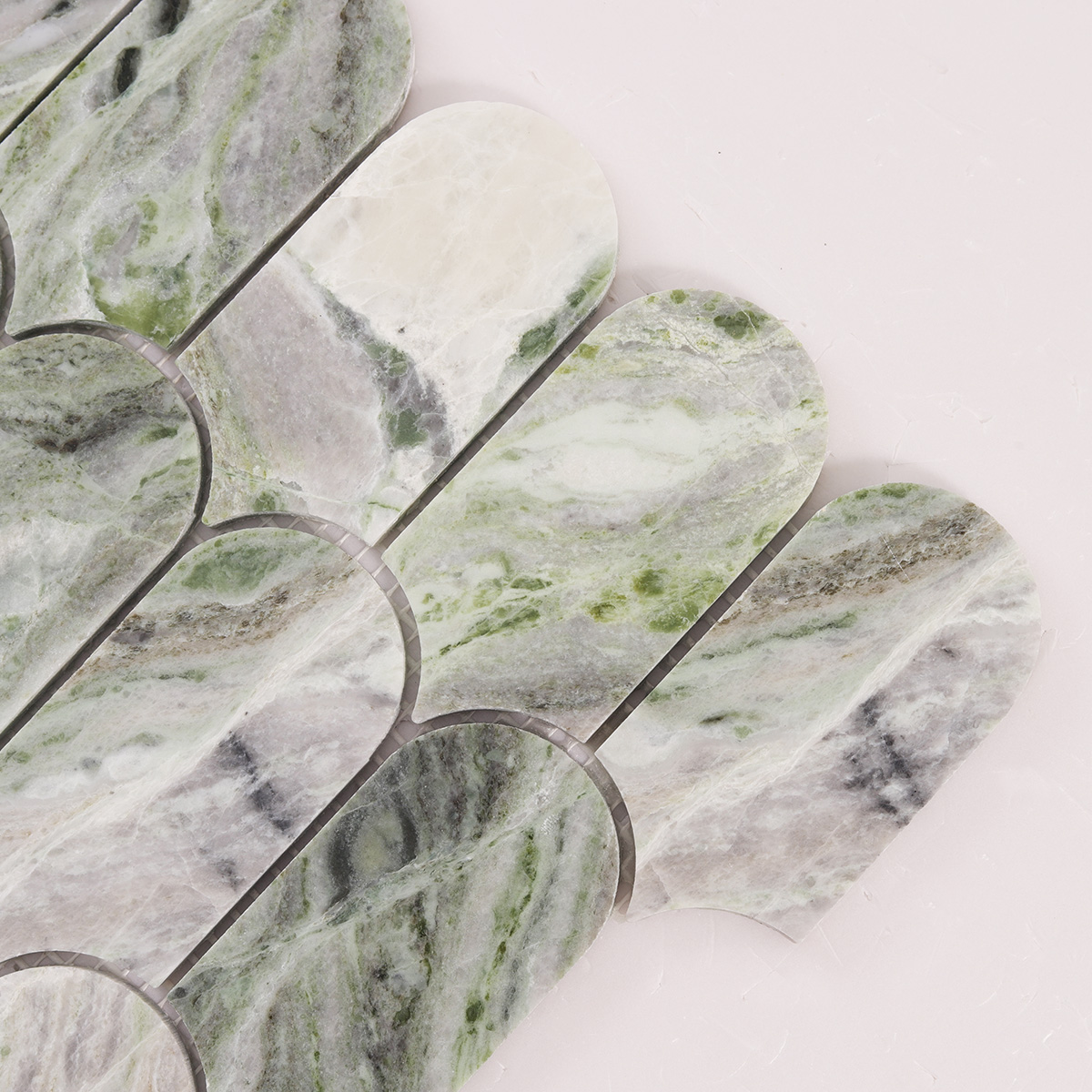 Detailed close-up of Envy Green long fish scale marble mosaic tiles