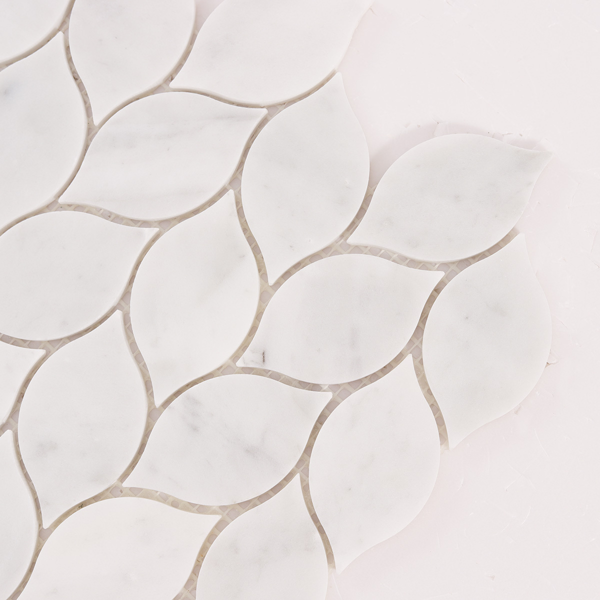 Detailed close-up of Carrara white leaf marble mosaic tiles