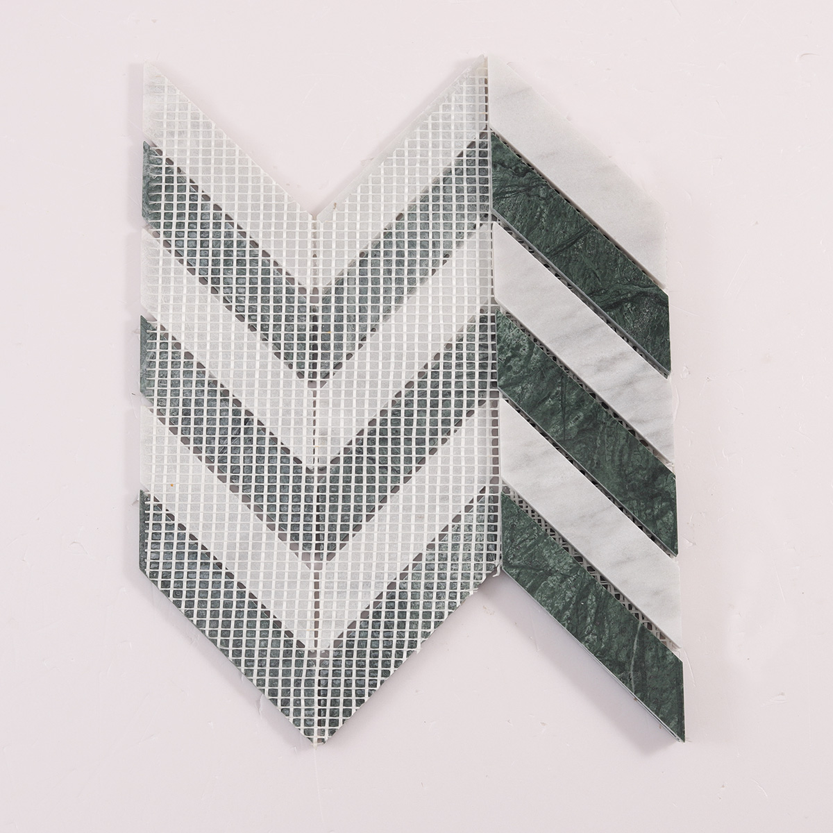 Back side of Green & White Herringbone Honed marble mosaic tiles, folded.