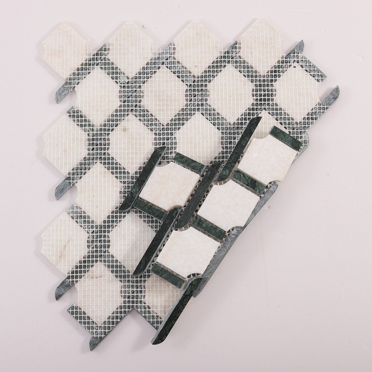 Back side of Thassos Green and White Princess Weave natural stone mosaic tiles, folded.
