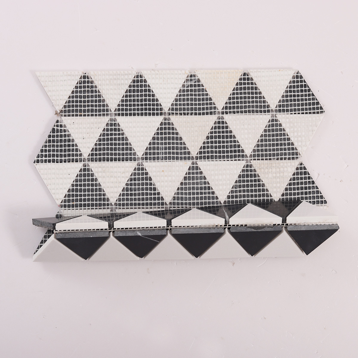Folded back side of White and Black Triangle Honed Stone Mosaic Tiles