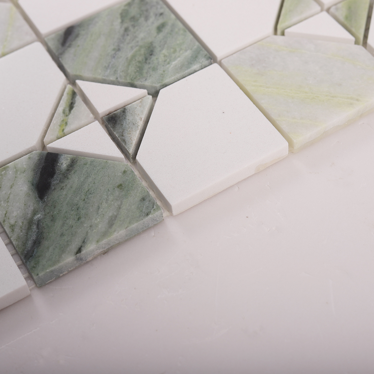 Side close-up view of Ming Green & White Marble Honed Mosaic Tiles, showing texture and thickness
