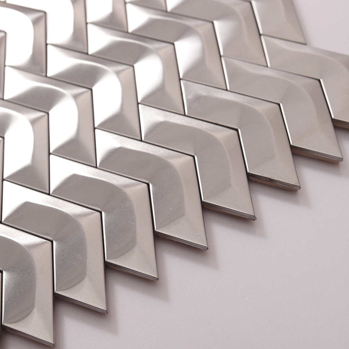 Side view close-up of 3D Silver Stainless Steel Mosaic Herringbone Backsplash Tile