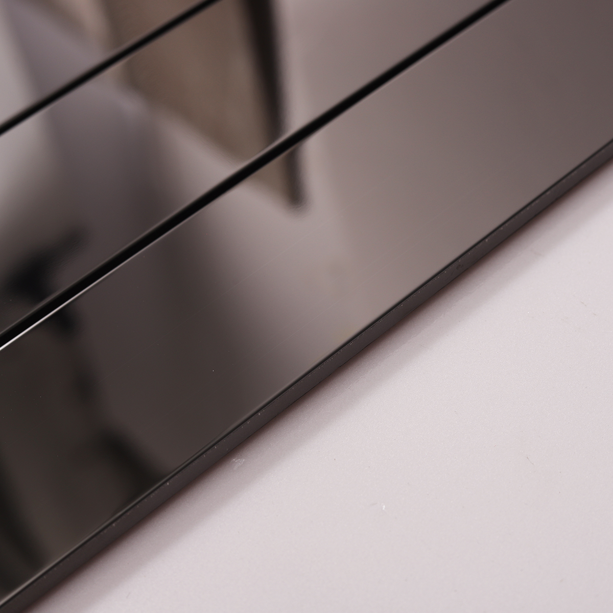 Side view close-up of Black Glossy Stainless Steel Brick Mosaic Tile, edge detail