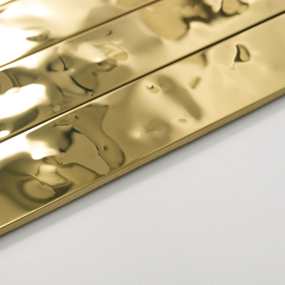 Side view close-up of Gold Wave Stainless Steel Brick Mosaic Tiles, edge detail