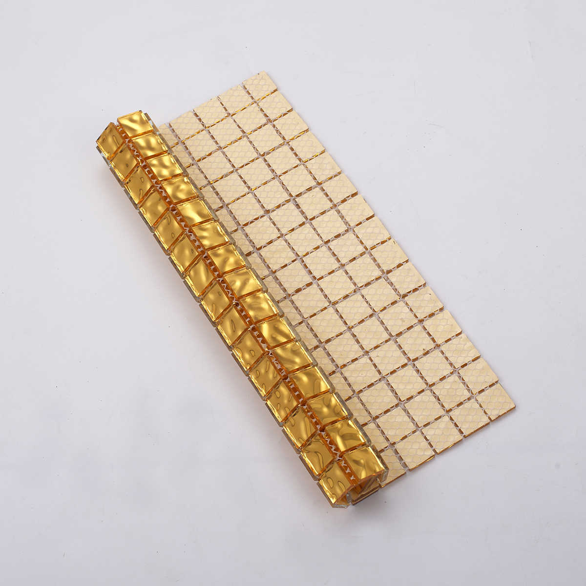 Glossy Gold Glass Uniform Square Mosaic Wall Tile, back side with fold visible, durable design