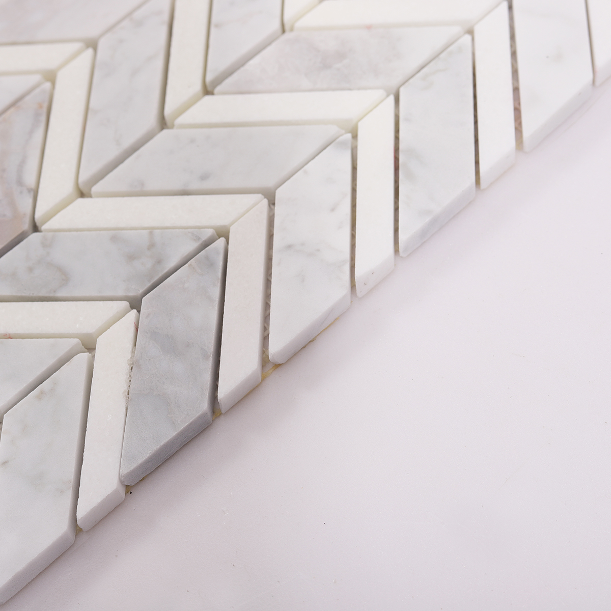 Side View Showing Thickness of Carrara White Marble Herringbone Tile