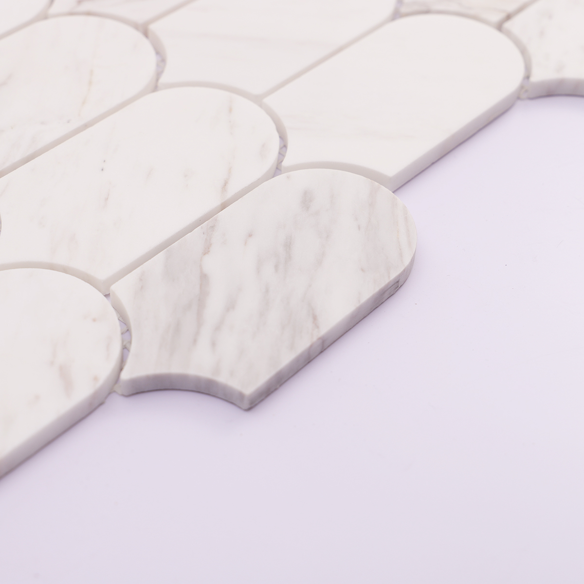 Side thickness detail of white marble mosaic tile, showing clean cut edges