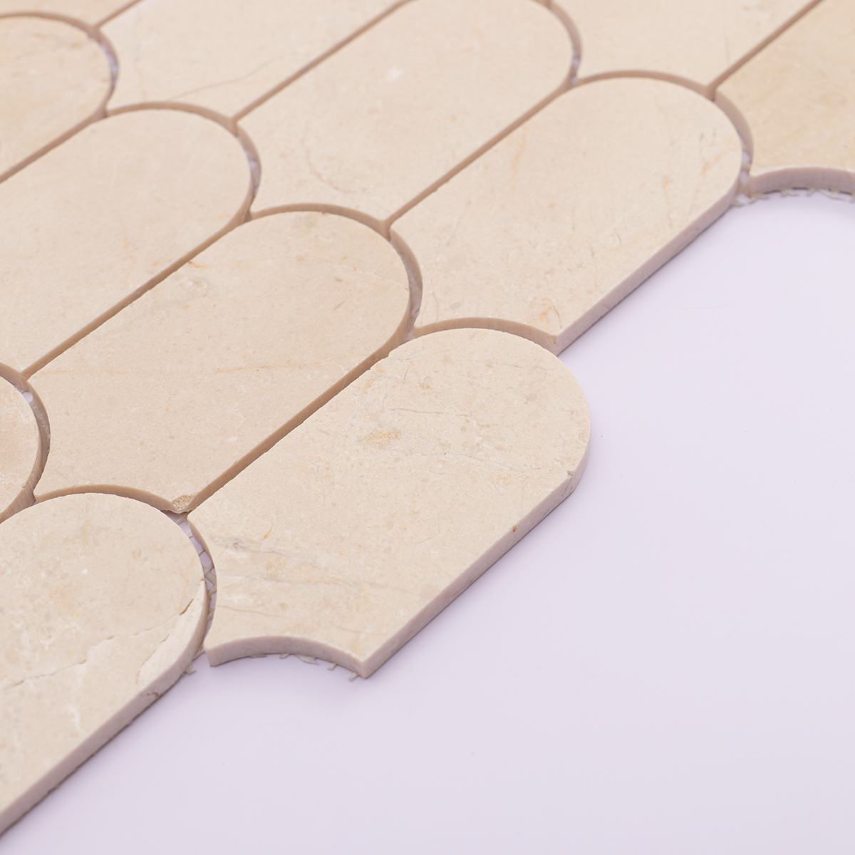 Side thickness detail of beige marble mosaic tile with clean, smooth edges