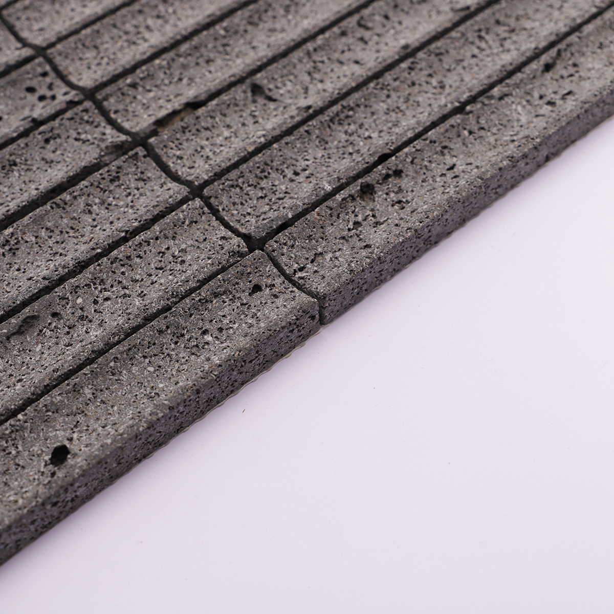Side view of the black lava stone mosaic showing its thickness