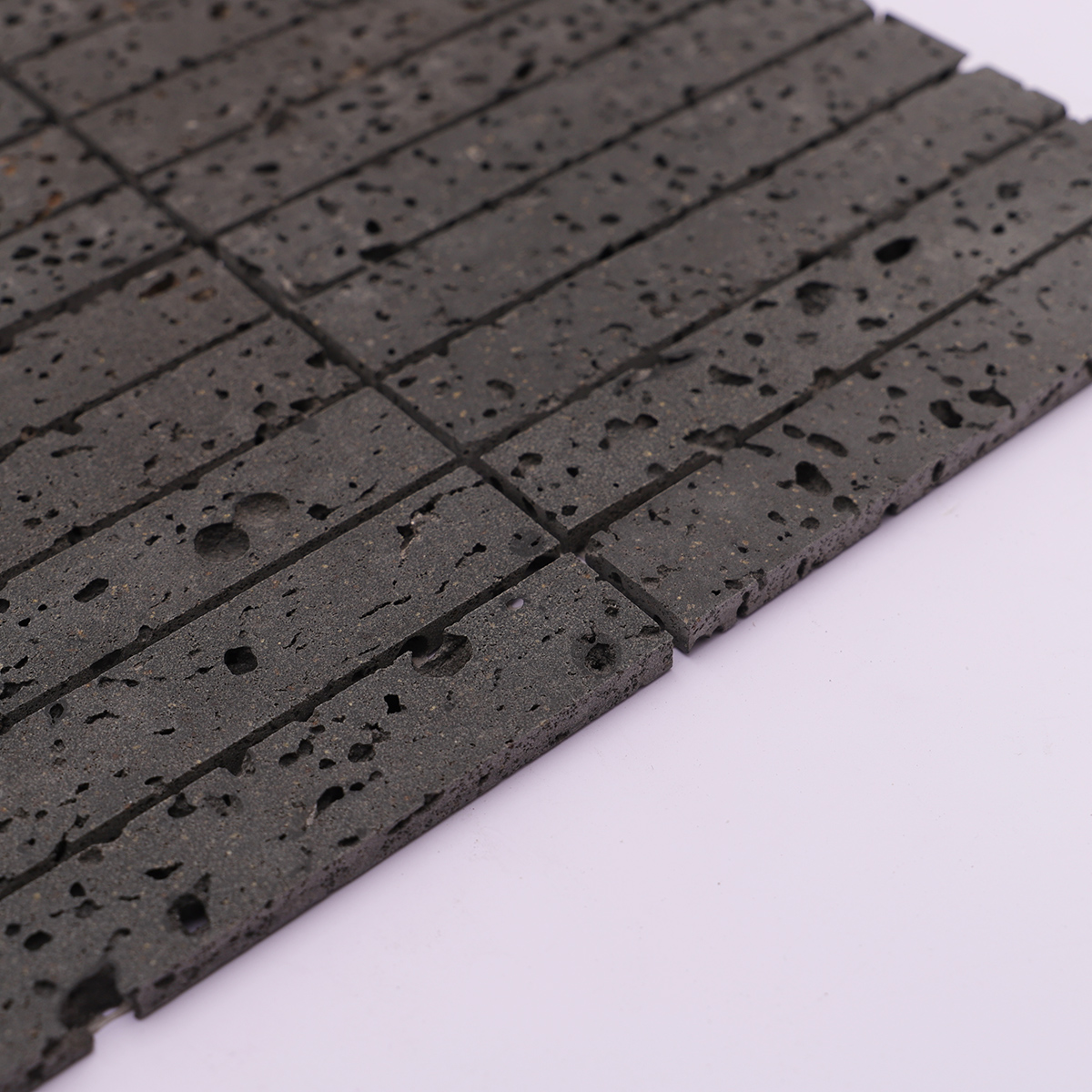 Side view showcasing the thickness of the black stone mosaic tiles