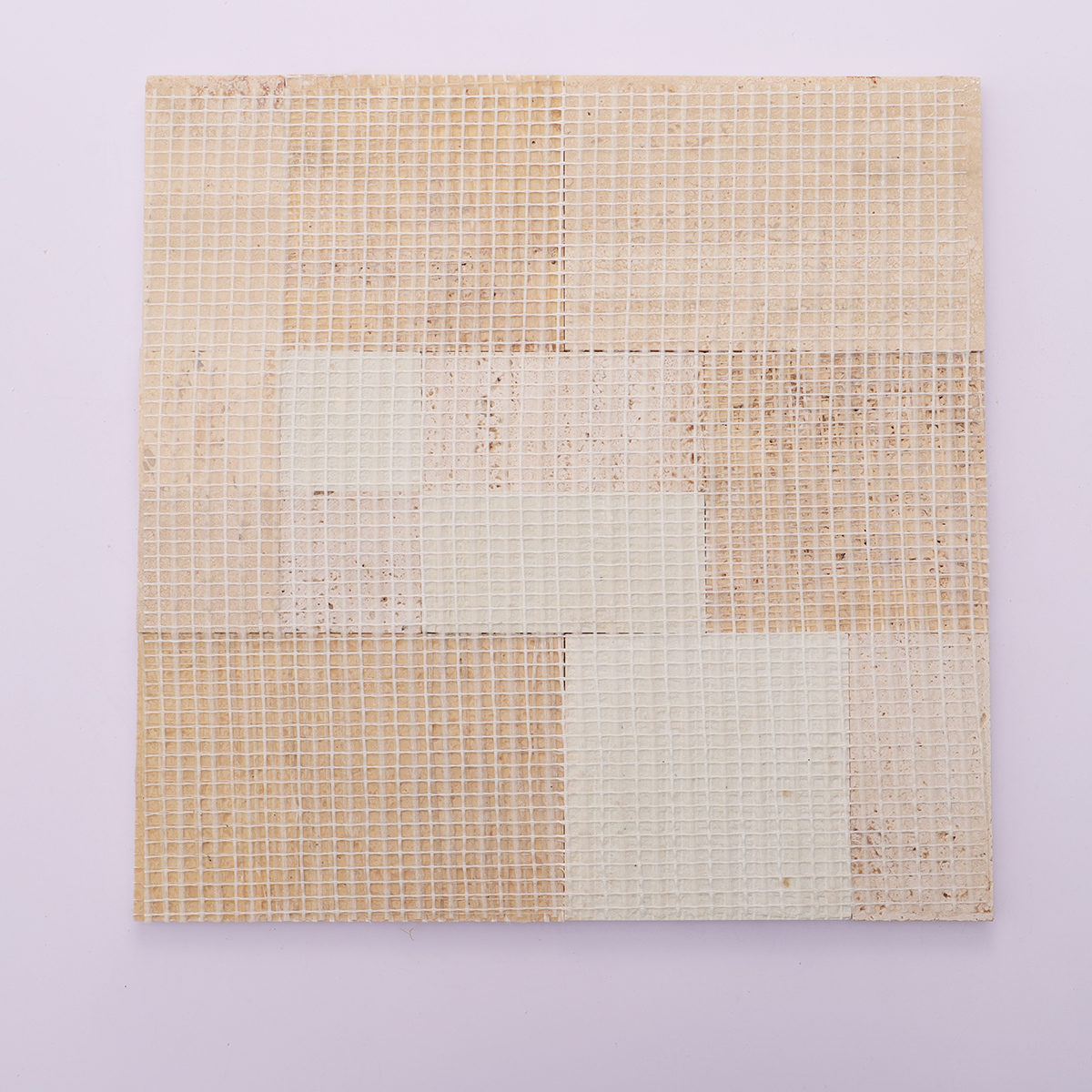 Back view with mesh backing of beige square 3D natural stone travertine mosaic tiles.