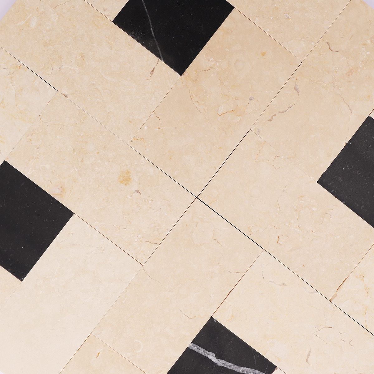 Detailed shot of the natural veins and polished finish of the beige and black marble tiles.