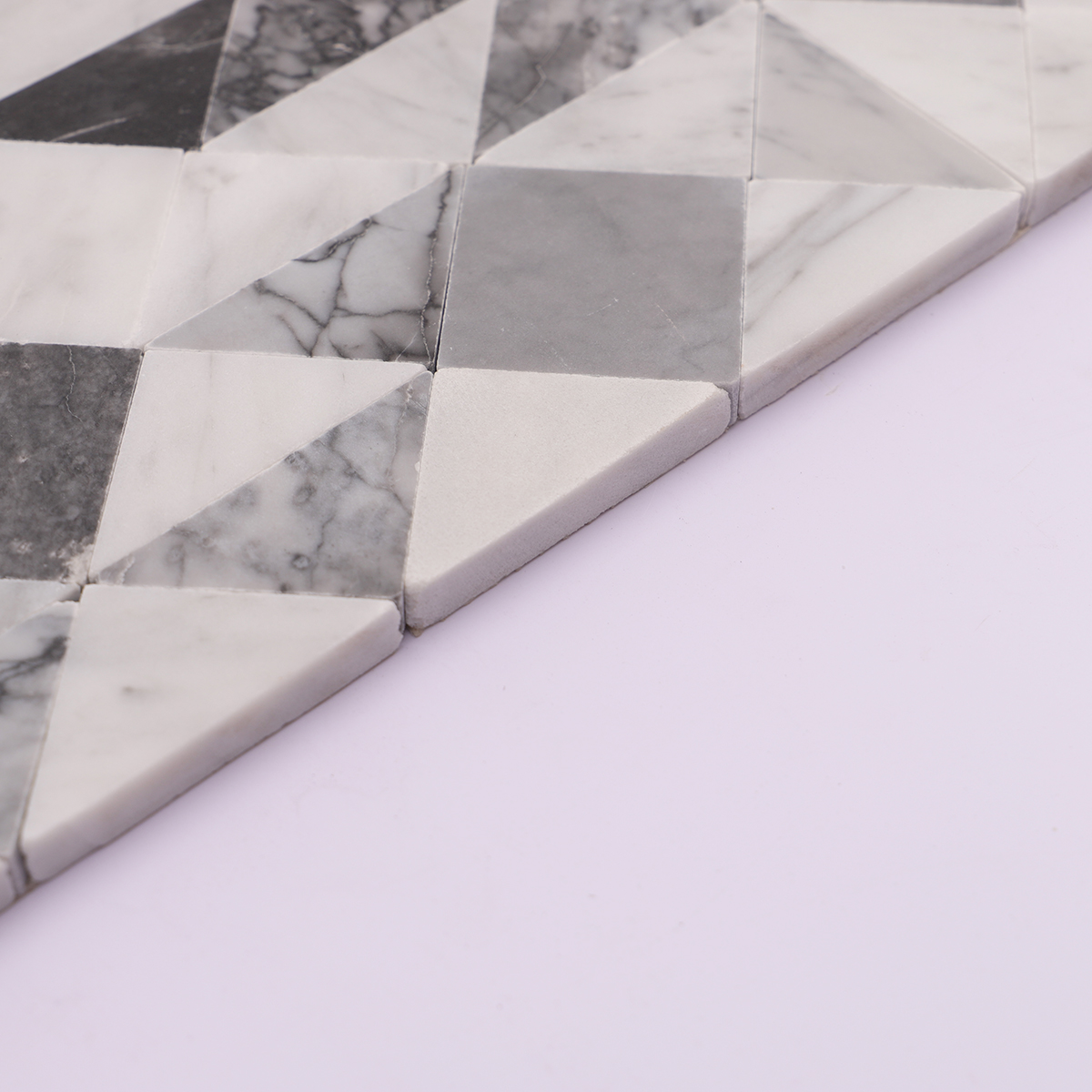 Side view showing the thickness of the grey and white marble mosaic tiles.