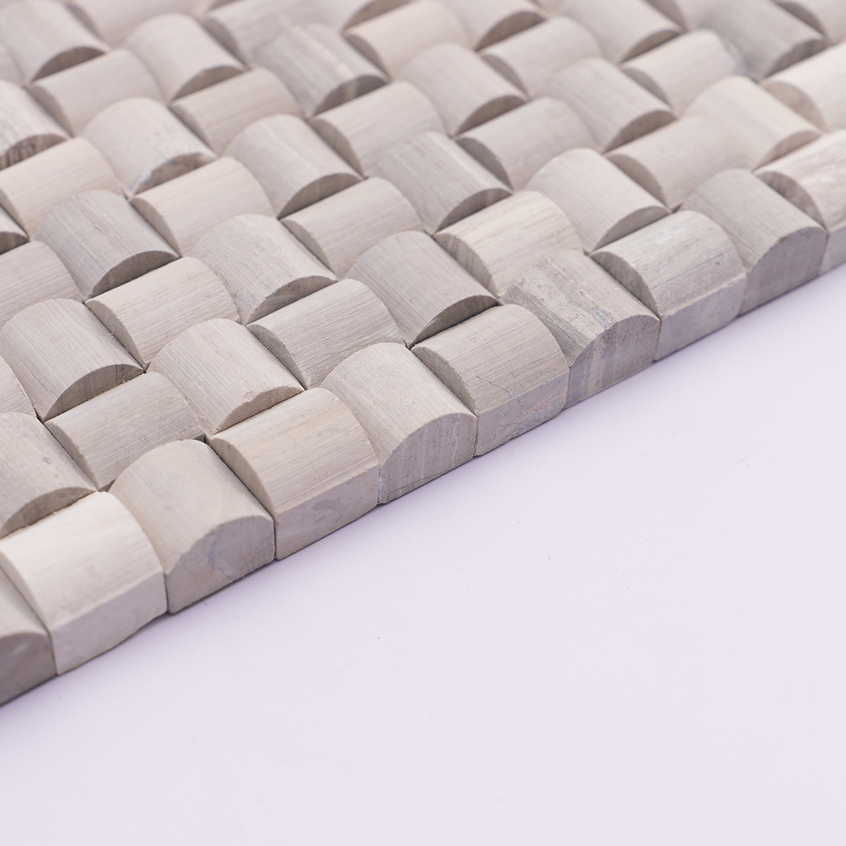 Side view showing the thickness of the 3D gray bread curved square marble mosaic tiles.