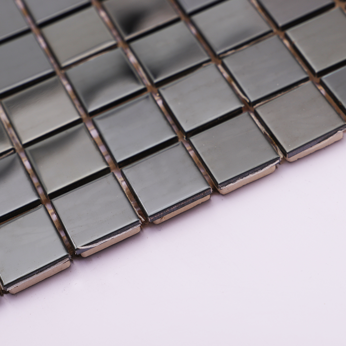 Side view showing the thickness of square mirror black stainless steel tiles.