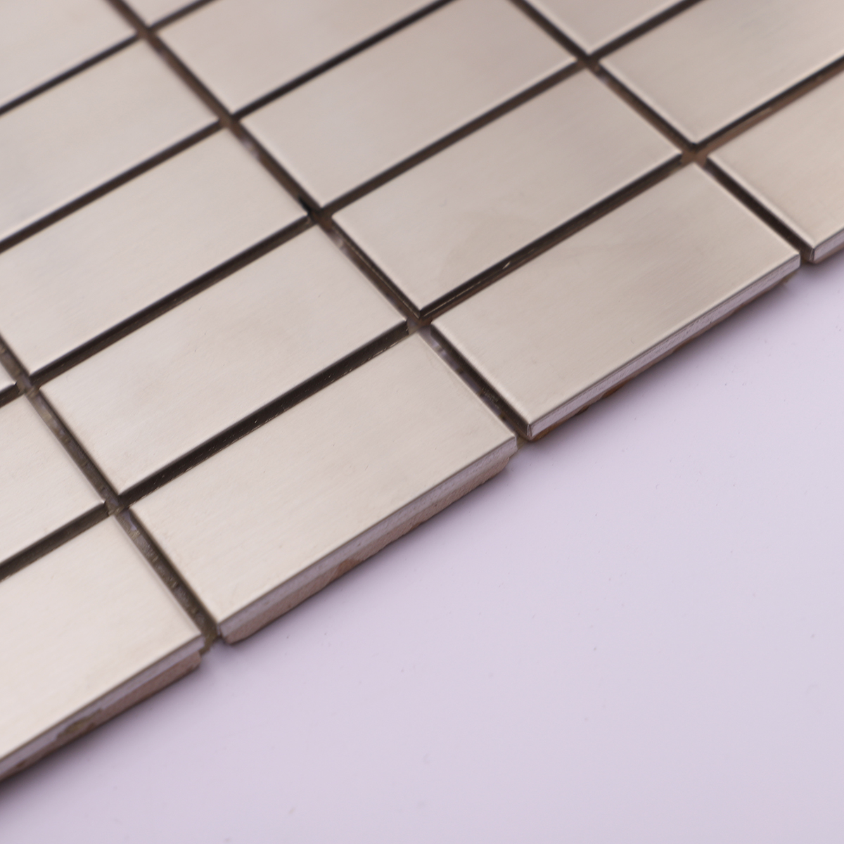 Angled view highlighting the thickness of the stainless steel brick tiles.