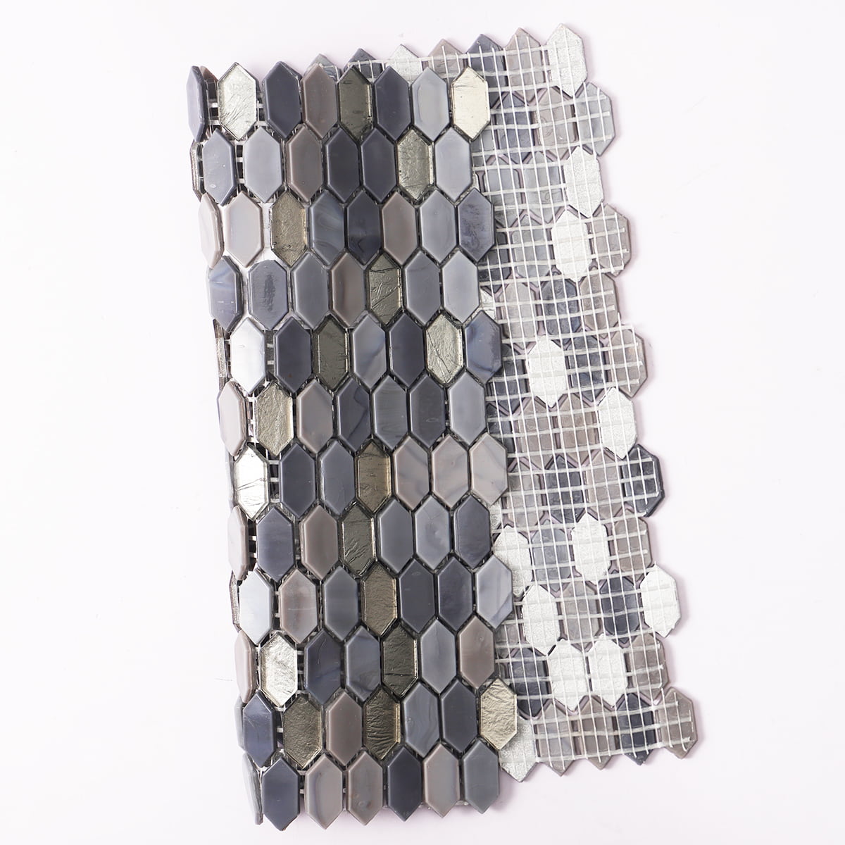 A roll of hexagonal mosaic tiles in dark gray and metallic shades