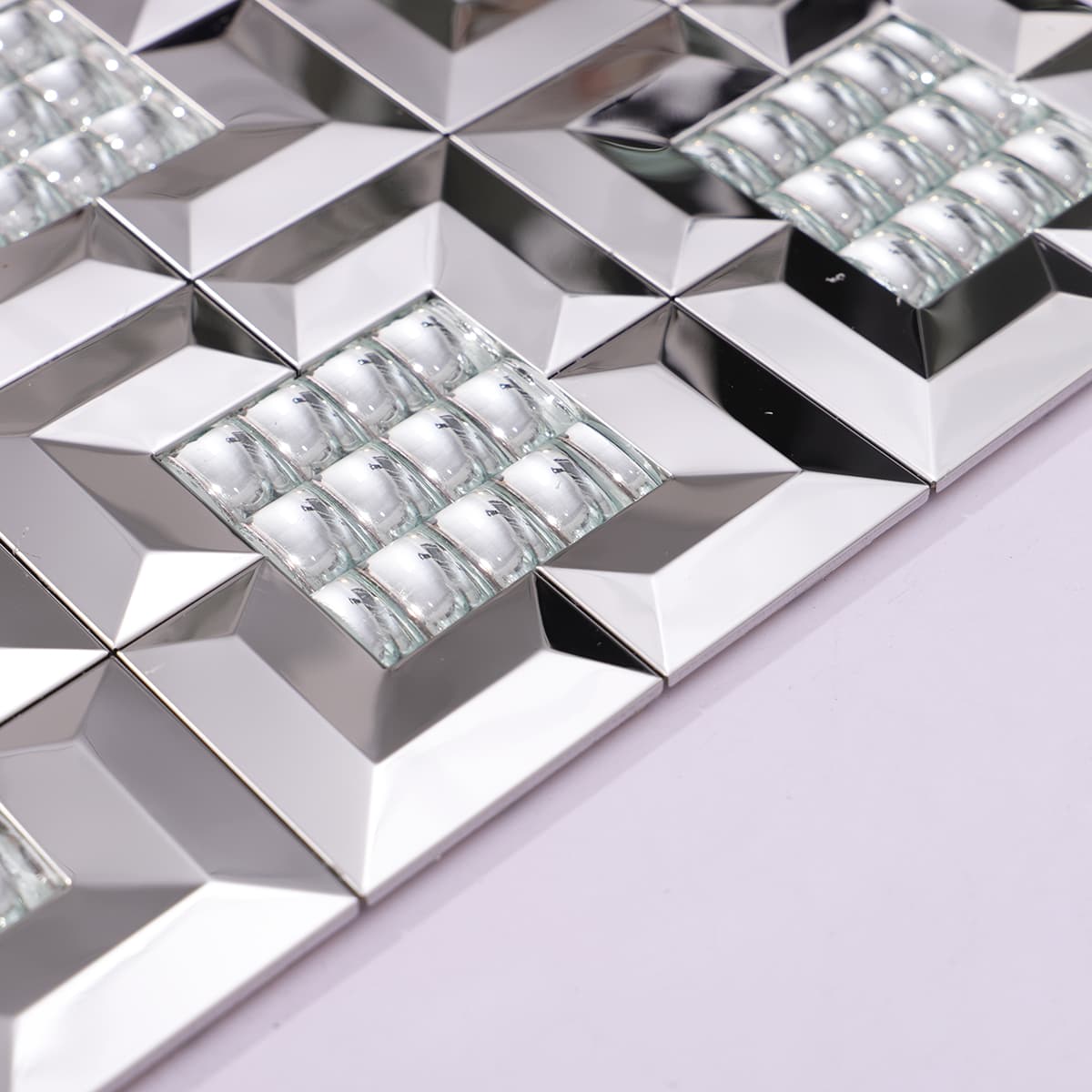 Close-up of silver metal tile edge with clear glass accents