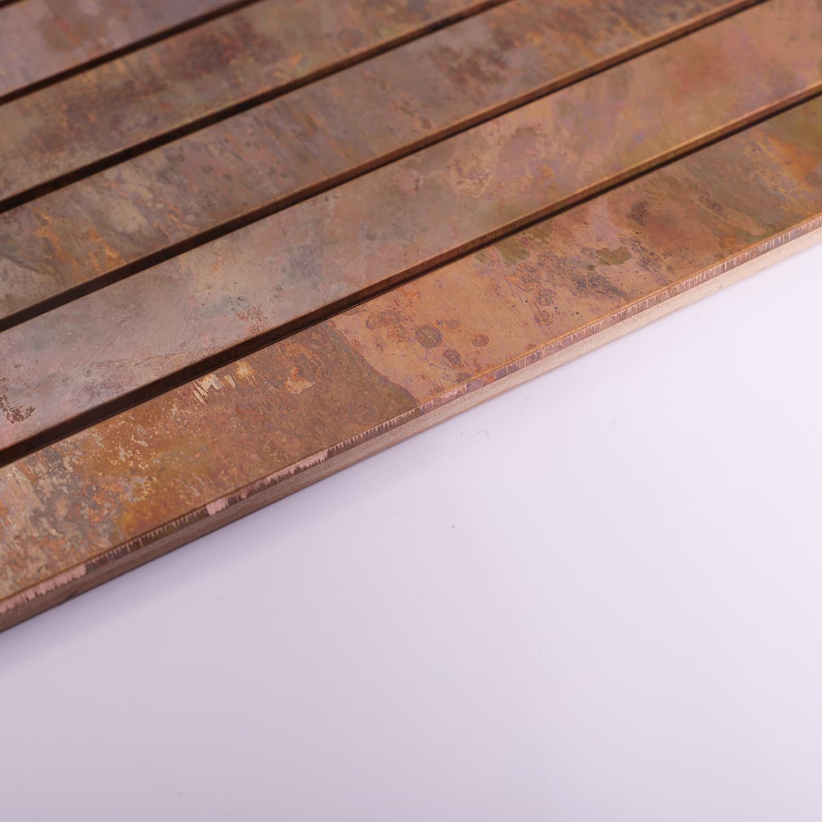 Vintage copper mosaic tile showing edge and thickness