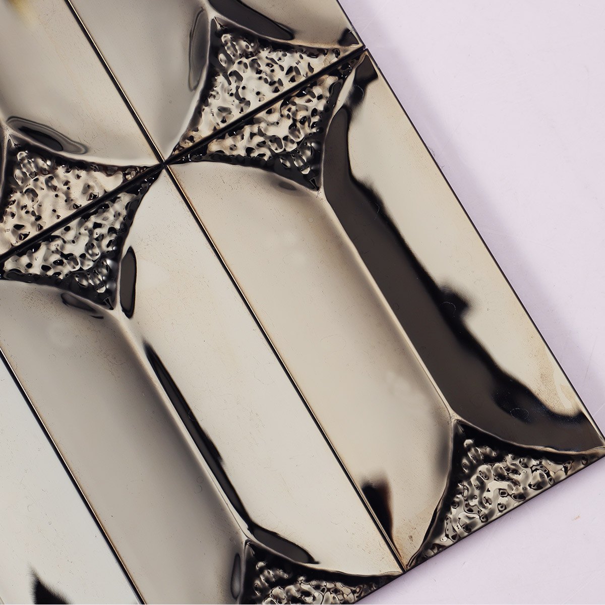 Surface detail close-up of 3D black mirror metal rectangle mosaic tiles.