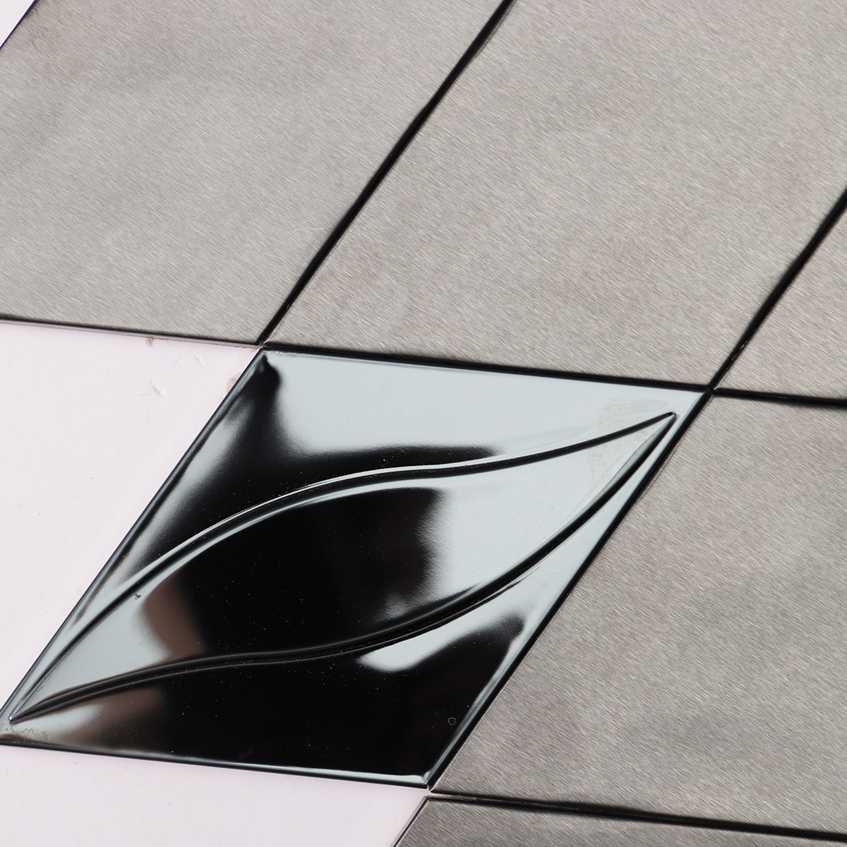 Macro close-up of black metal stainless steel diamond mosaic tiles.