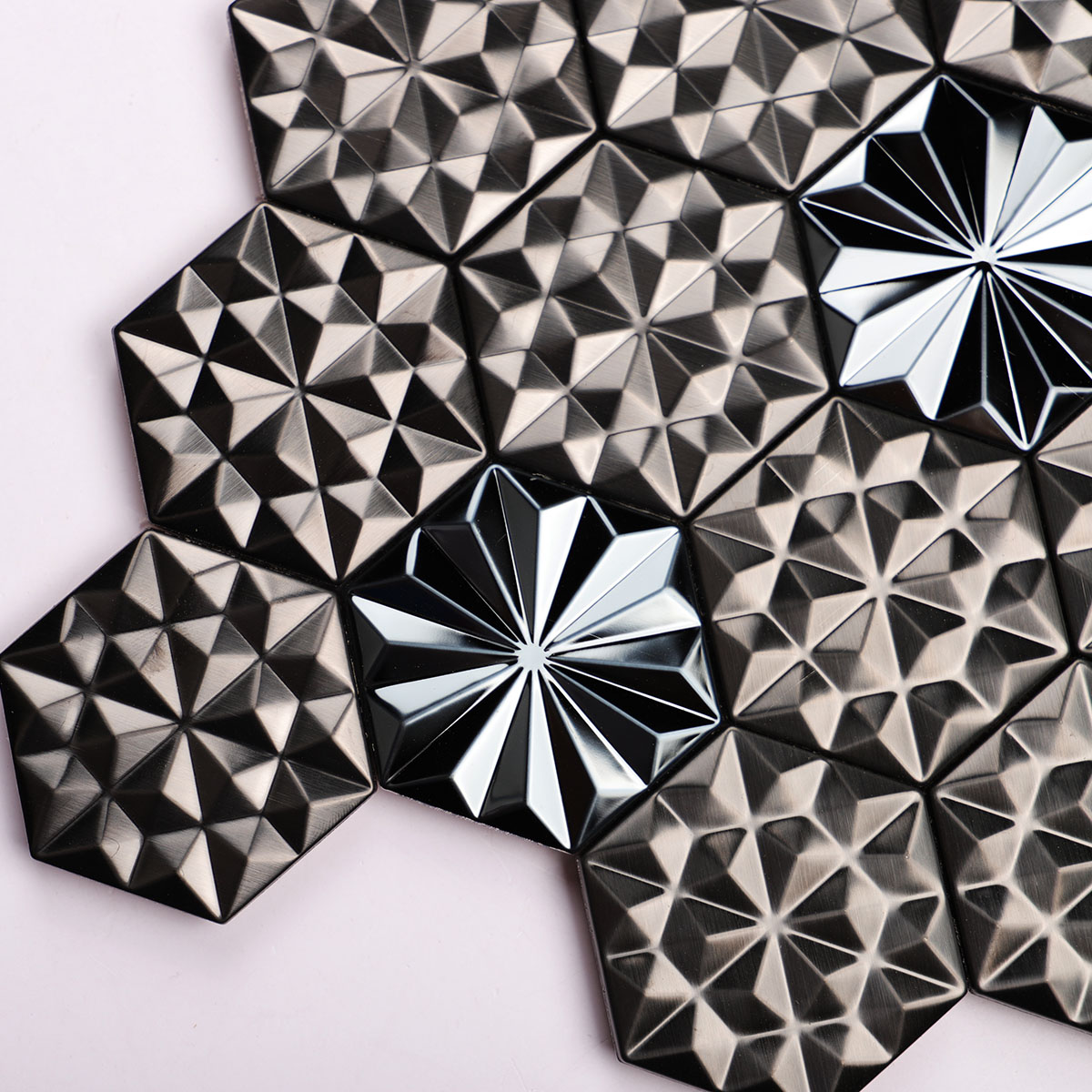 Texture close-up of black metal 3D groutless hexagon mosaic tile in stainless steel.