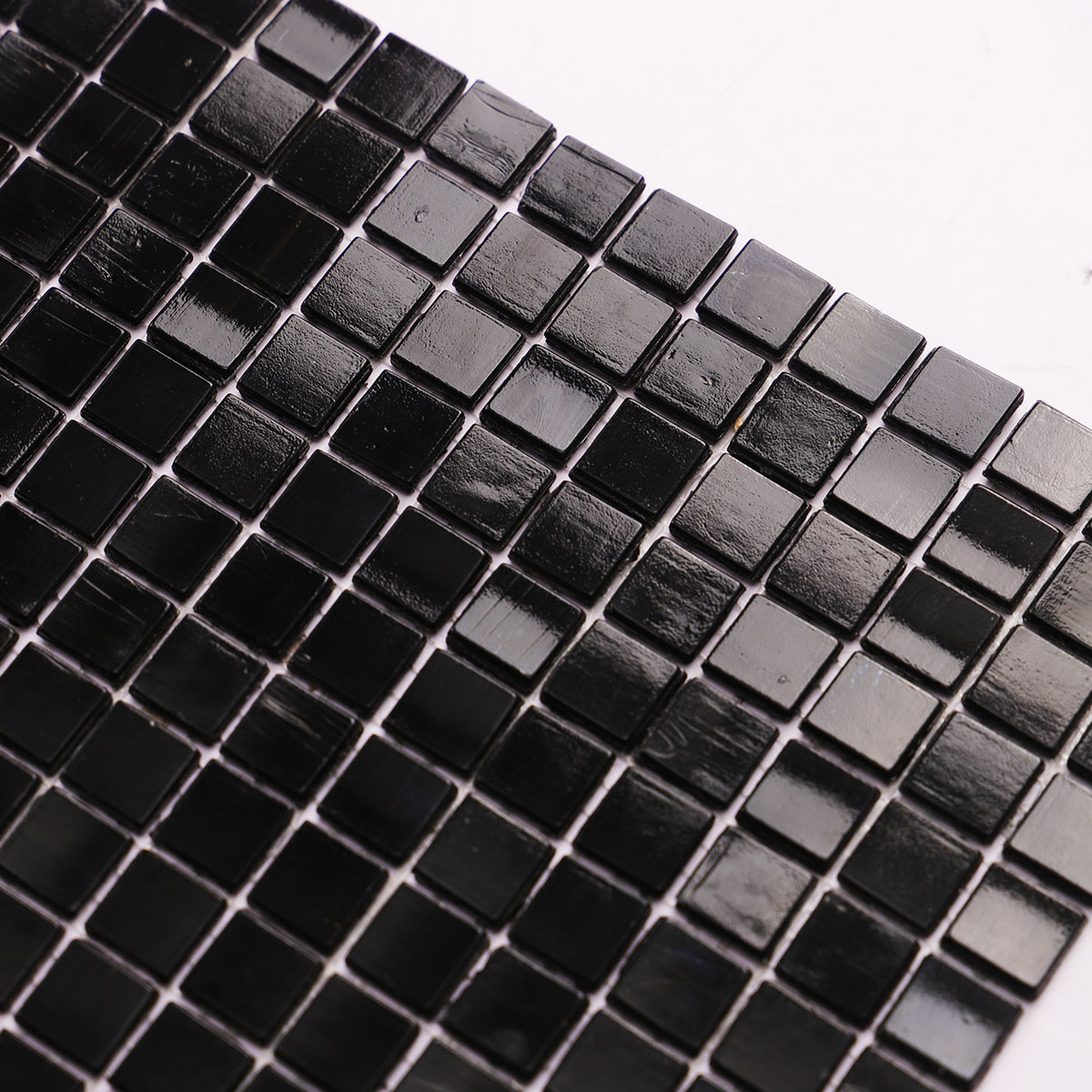 Close-up of pure black glass mosaic tiles.