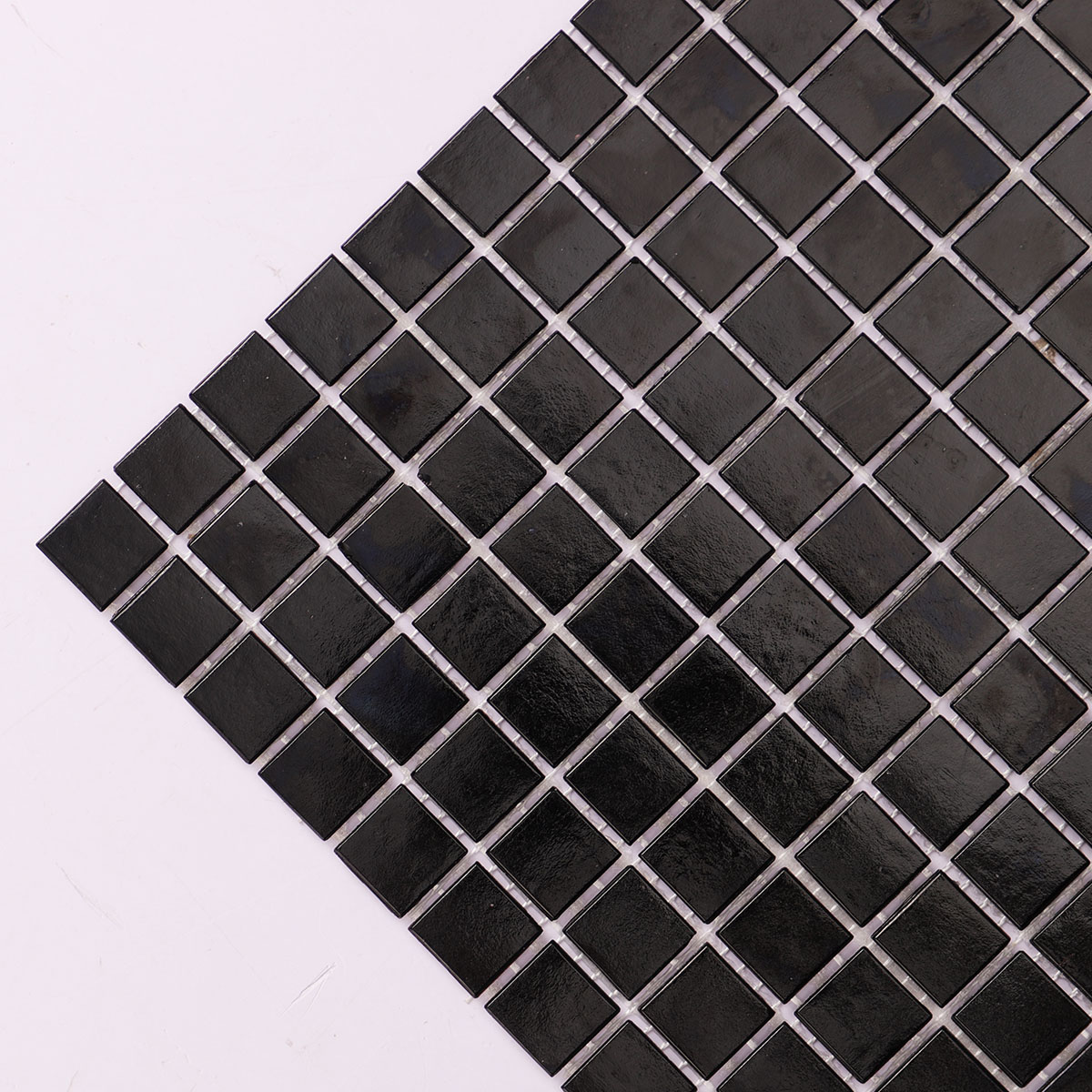 Detailed close-up of black fired earth glass square mosaic tiles 20mm x 20mm.