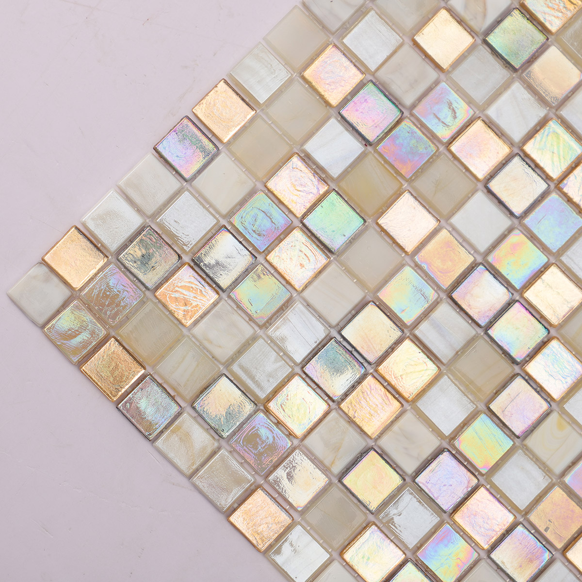 Detailed close-up of beige and gold iridescent glass mosaic tiles mixed.