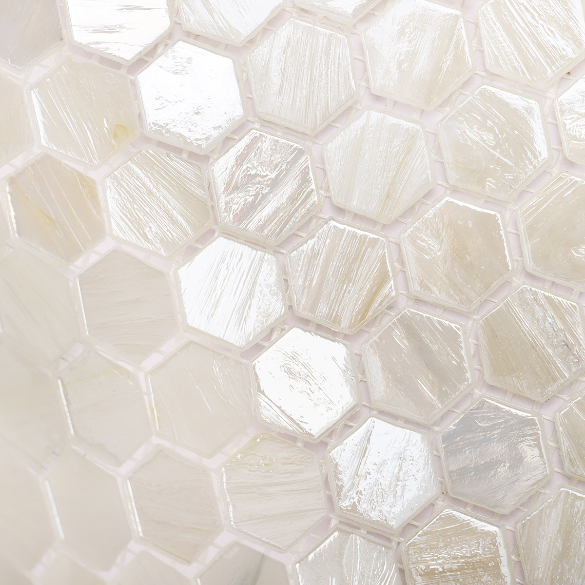 Close-up view of beige flash hexagon glass mosaic tiles.
