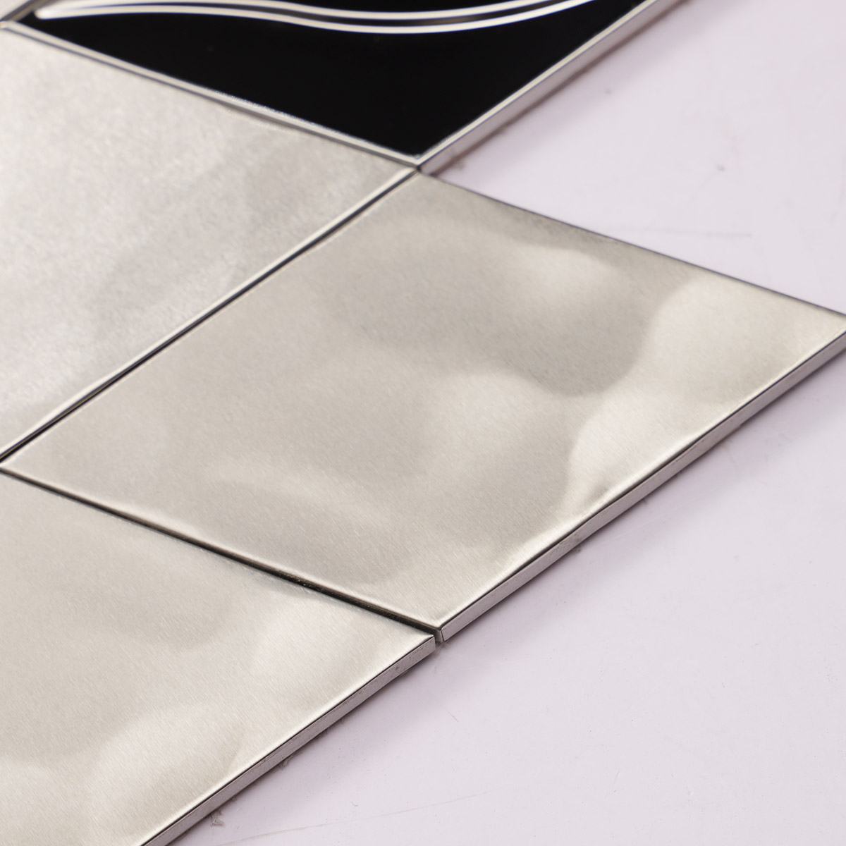 Close-up of the side of mirror silver diamond stainless steel mosaic tiles.