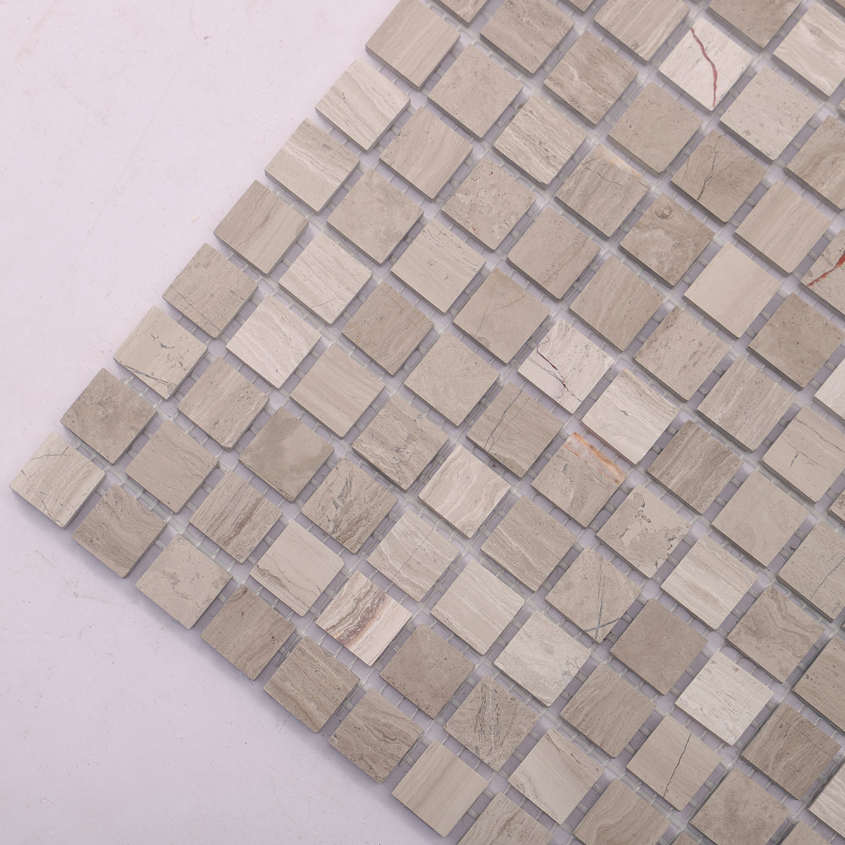 Close-up view of Grigio Imperiale square marble mosaic tiles.