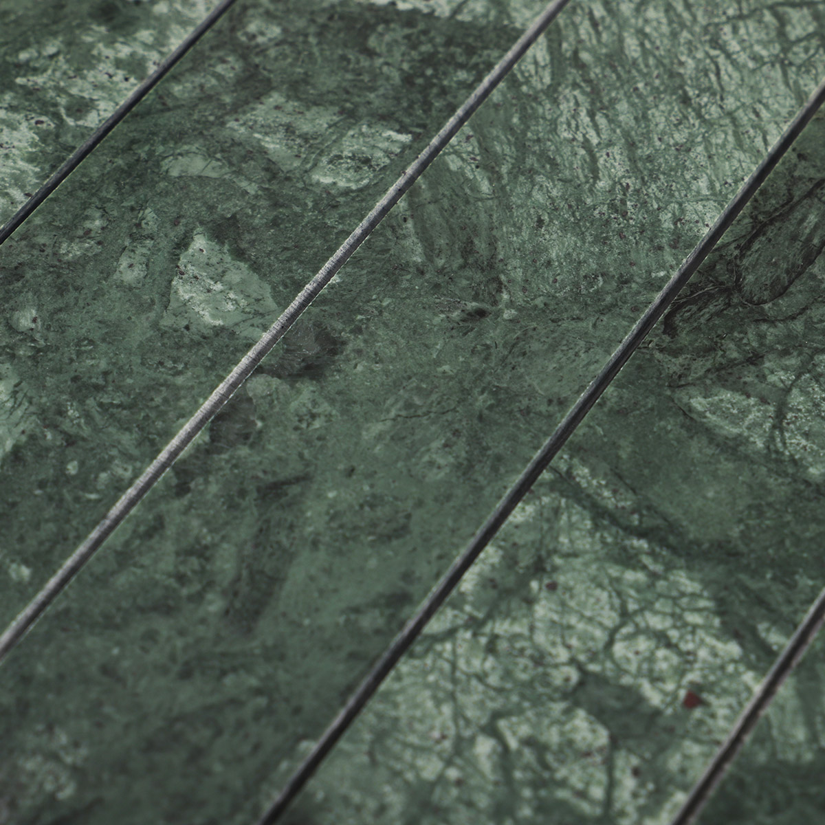 Close-up of long strip dark green marble mosaic tiles.