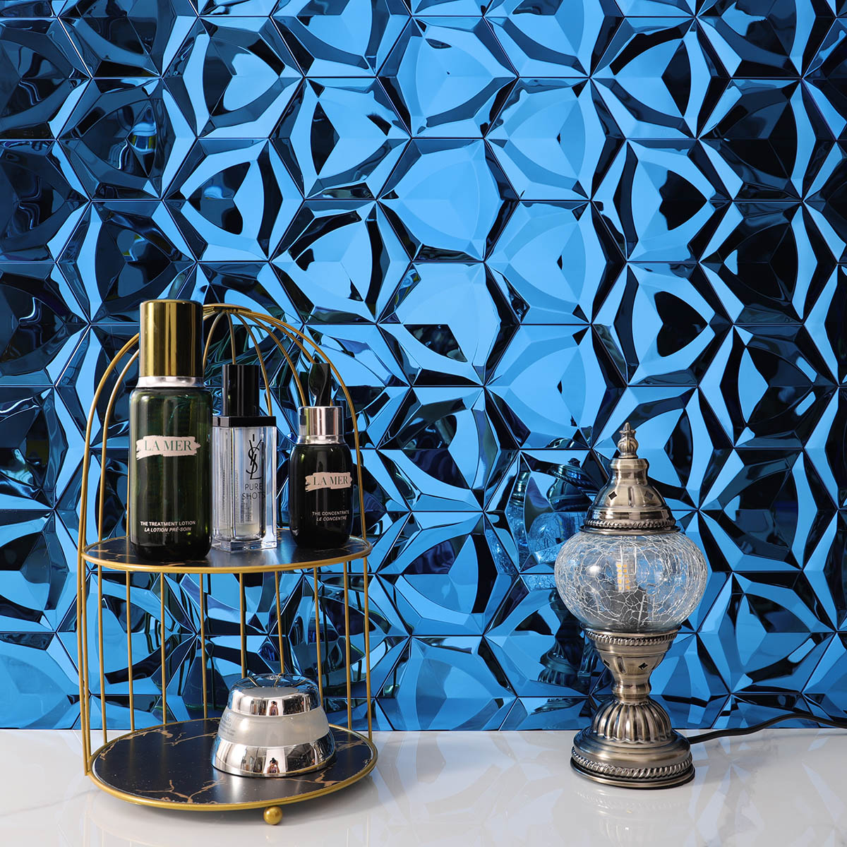 3D blue hexagon stainless steel mosaic tiles on a bathroom wall.