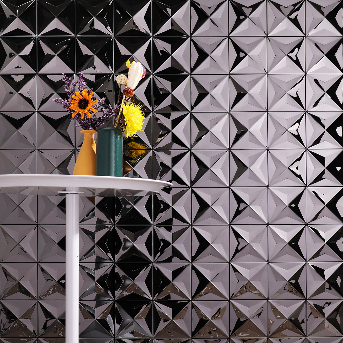 Accent wall with black 3D mirror metallic mosaic tiles.