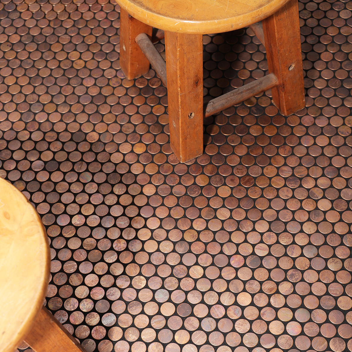 Penny rounds copper mosaic tiles on the living room floor 