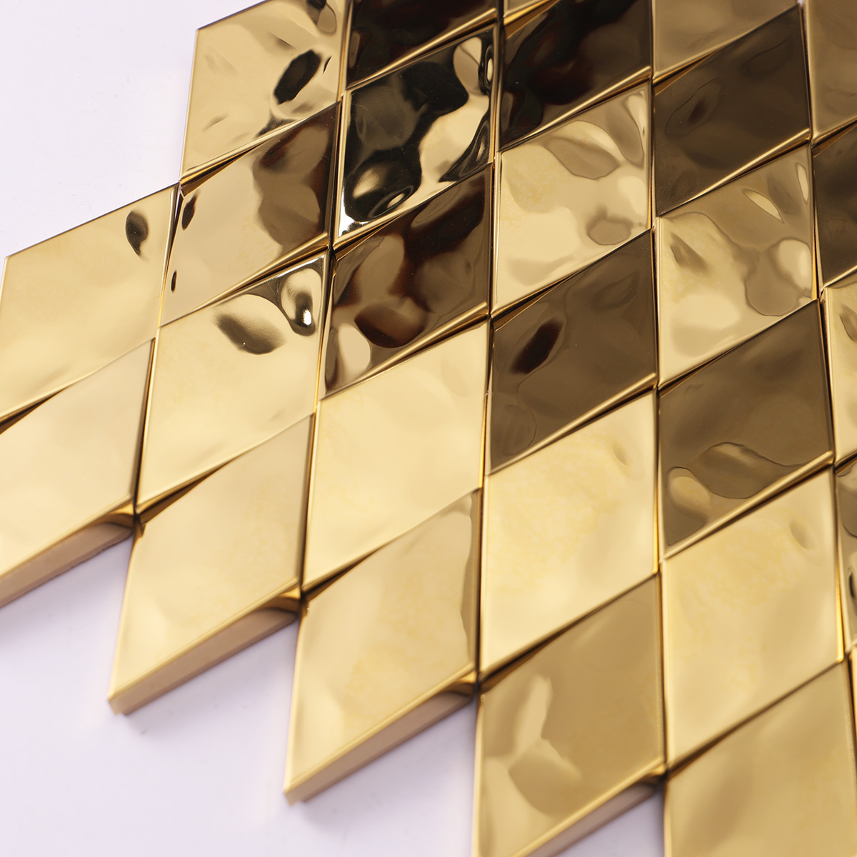 Detailed close-up of gold diamond 3D stainless steel metal mosaic wall tiles.