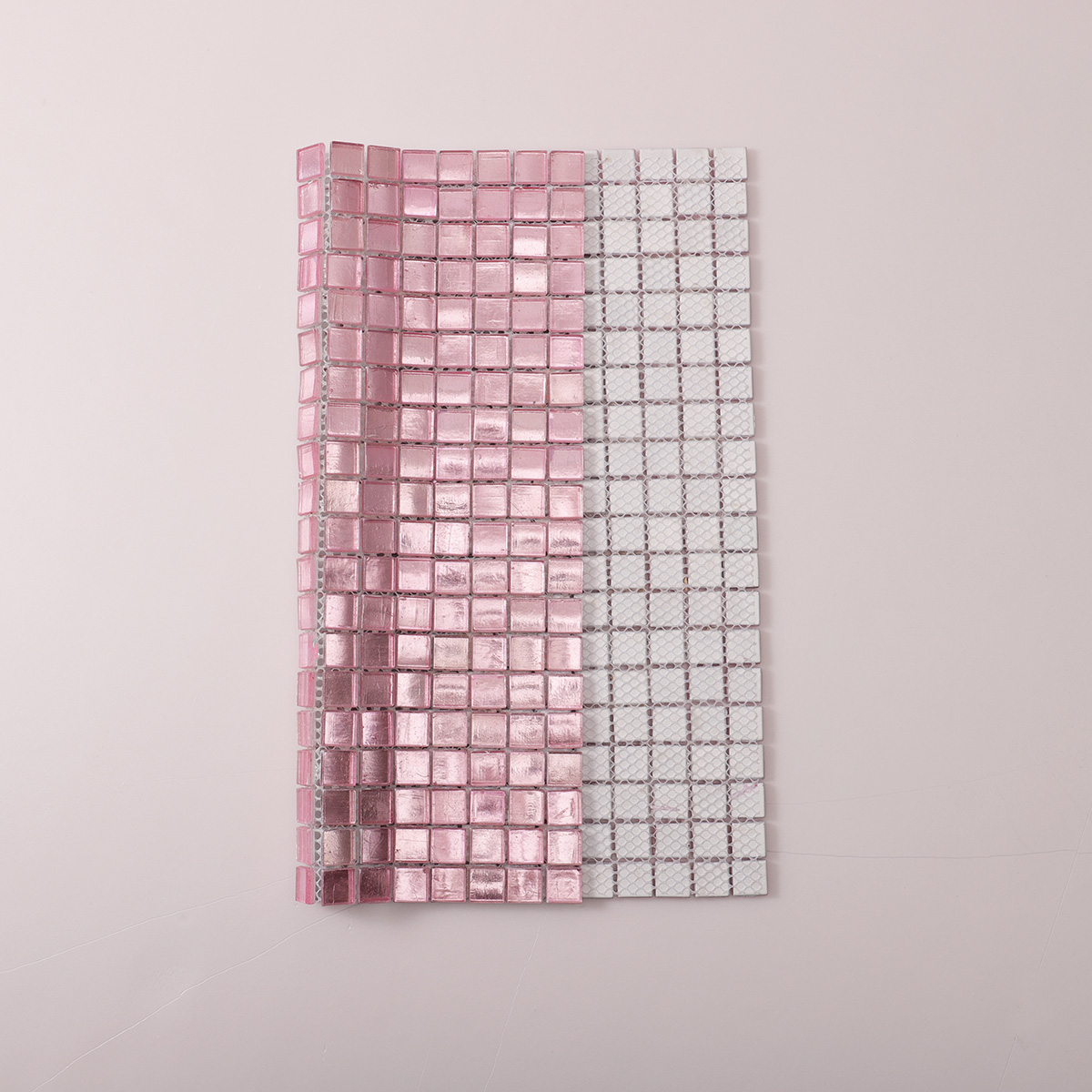 Folded back side of pink metallic foil glass mosaic tiles.