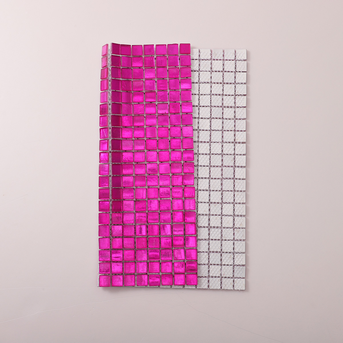 Folded back side of hot pink foil square glass mosaic tiles.