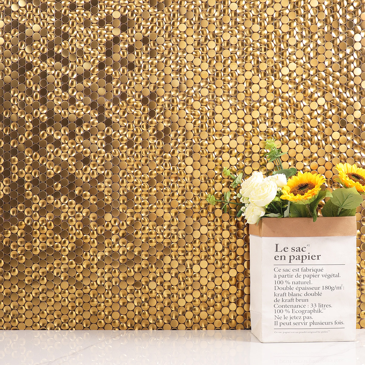 Living room wall adorned with penny round gold metal mosaic tiles.
