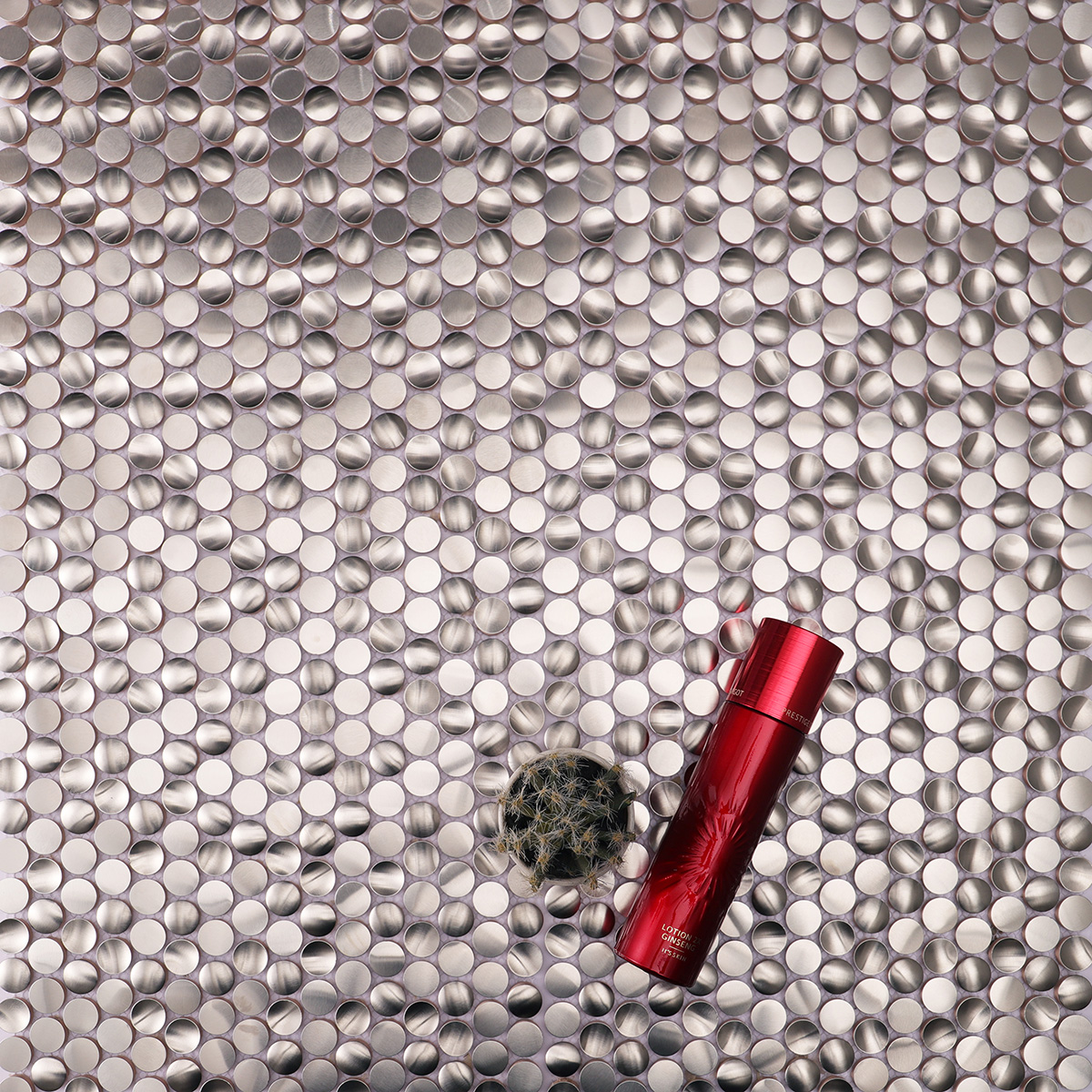 Close-up view of 3D penny round silver stainless steel mosaic tiles