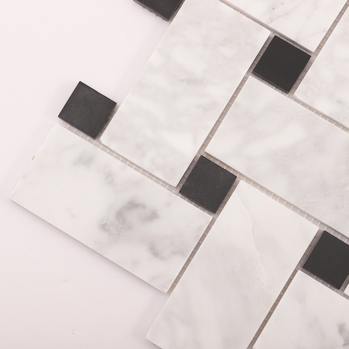 Macro close-up of Carrara white basketweave marble mosaic tiles