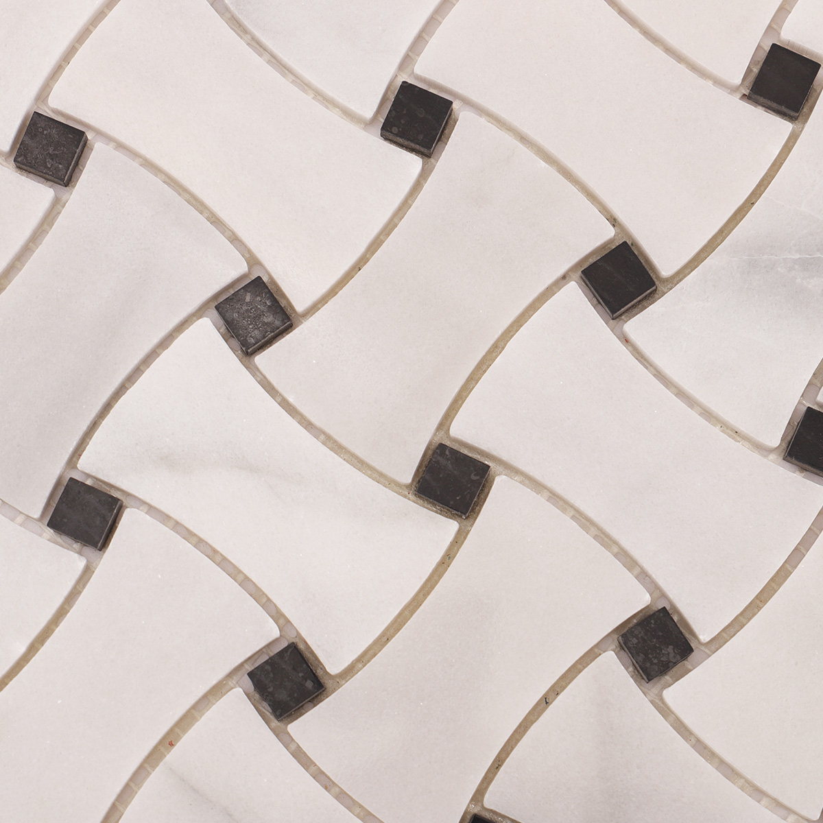 Detailed close-up of Carrara white basketweave marble mosaic tiles with black dots