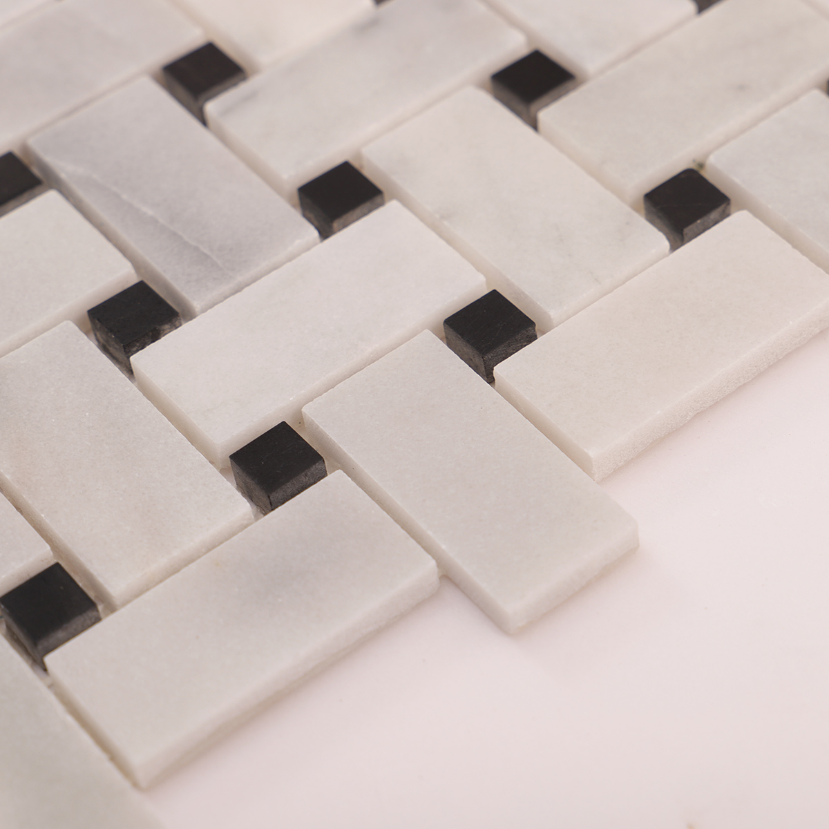 Close-up of Carrara white basketweave marble mosaic tiles