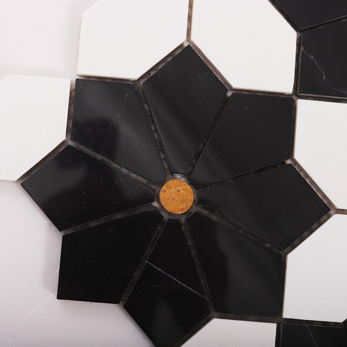 Close-up of white and black floral marble mosaic tiles