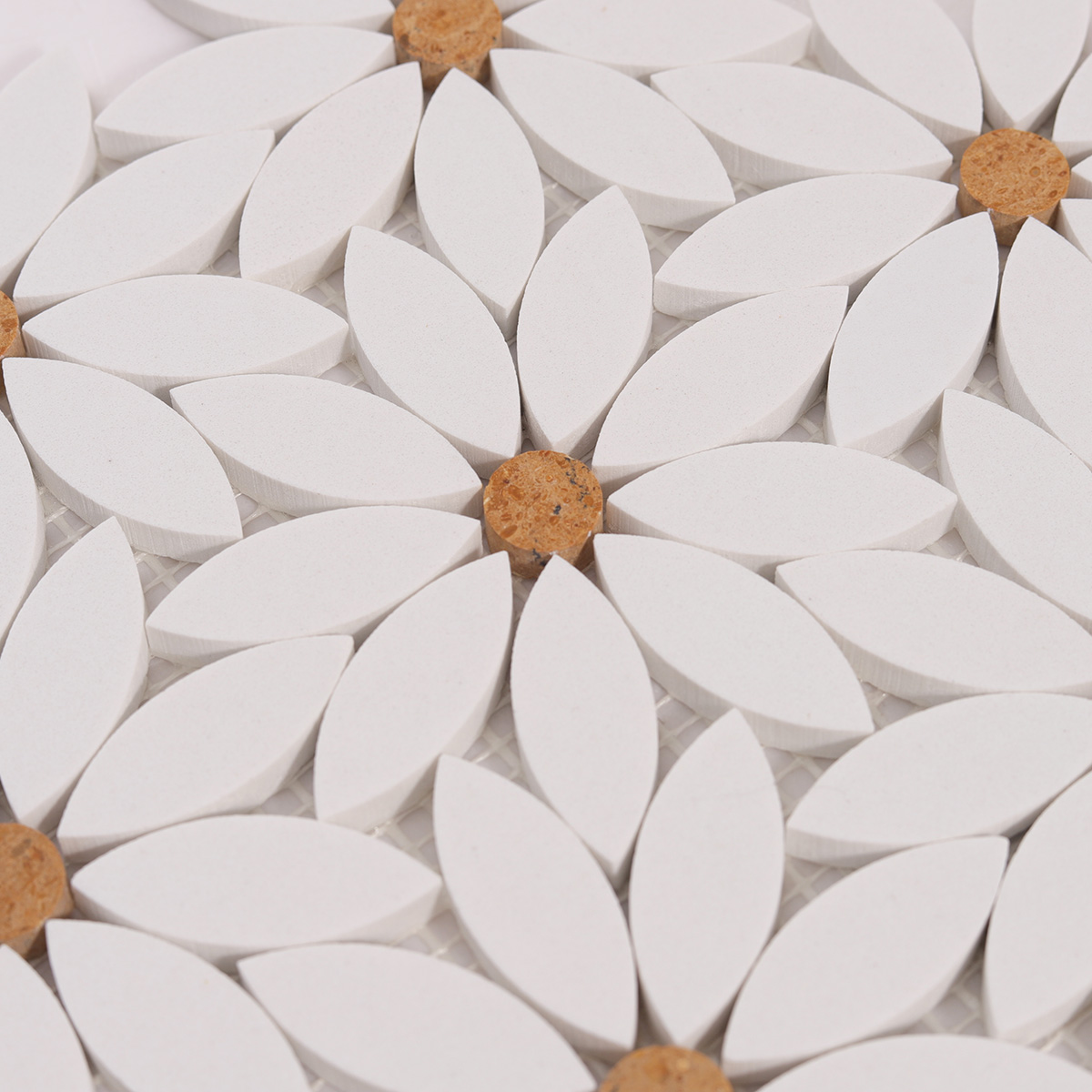 Detailed close-up of white waterjet sunflower marble mosaic tiles.
